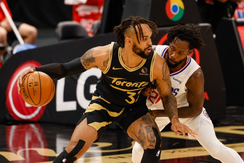 May 11, 2021; Tampa, Florida, USA;  Toronto Raptors guard Gary Trent Jr. (33) dribbles the ball against LA Clippers guard Patrick Beverley (21) in the first quarter at Amalie Arena. Mandatory Credit: Nathan Ray Seebeck-USA TODAY Sports