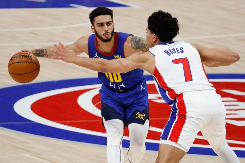 May 14, 2021; Detroit, Michigan, USA; Denver Nuggets guard Markus Howard (00) dribbles defended by Detroit Pistons guard Killian Hayes (7) in the second half at Little Caesars Arena. Mandatory Credit: Rick Osentoski-USA TODAY Sports