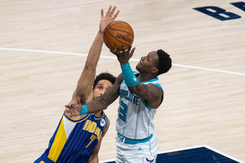 May 18, 2021; Indianapolis, Indiana, USA; Charlotte Hornets guard Terry Rozier (3) shoots the ball while Indiana Pacers guard Malcolm Brogdon (7) defends in the third quarter at Bankers Life Fieldhouse. Mandatory Credit: Trevor Ruszkowski-USA TODAY Sports