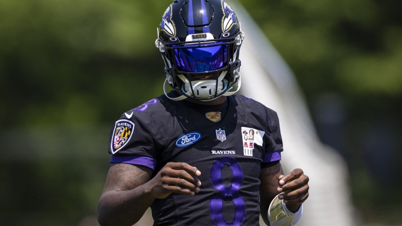 May 26, 2021; Owings Mills, Maryland, USA; Baltimore Ravens quarterback Lamar Jackson (8) looks on during an OTA at Under Armour Performance Center. Mandatory Credit: Scott Taetsch-USA TODAY Sports