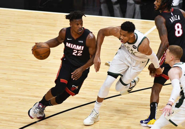 May 27, 2021; Miami, Florida, USA; Miami Heat forward Jimmy Butler (22) drives to the basket as Milwaukee Bucks forward Giannis Antetokounmpo (34) defends on the play in the first half during game three in the first round of the 2021 NBA Playoffs at American Airlines Arena. Mandatory Credit: Jim Rassol-USA TODAY Sports
