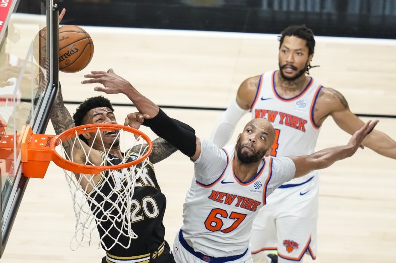 May 30, 2021; Atlanta, Georgia, USA; Atlanta Hawks forward John Collins (20) gets fouled by New York Knicks center Taj Gibson (67) during the first half in game four in the first round of the 2021 NBA Playoffs at State Farm Arena. Mandatory Credit: Dale Zanine-USA TODAY Sports