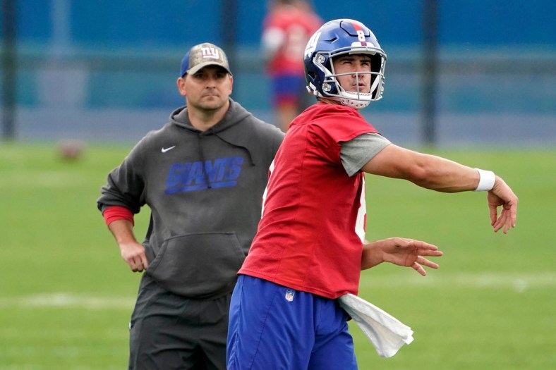 New York Giants quarterback Daniel Jones (8) throws the ball as head coach Joe Judge looks on during OTA practice at the Quest Diagnostics Training Center on Friday, June 4, 2021, in East Rutherford.Giants Ota Practice