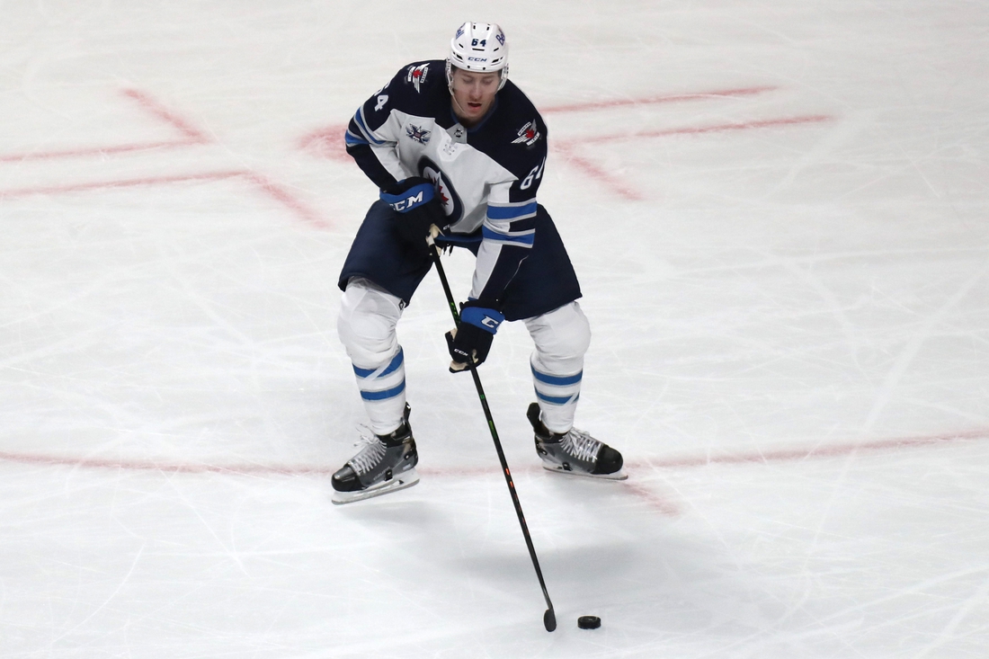 Jun 7, 2021; Montreal, Quebec, CAN; Winnipeg Jets defenseman Logan Stanley (64) plays the puck against Montreal Canadiens during the second period in game four of the second round of the 2021 Stanley Cup Playoffs at Bell Centre. Mandatory Credit: Jean-Yves Ahern-USA TODAY Sports