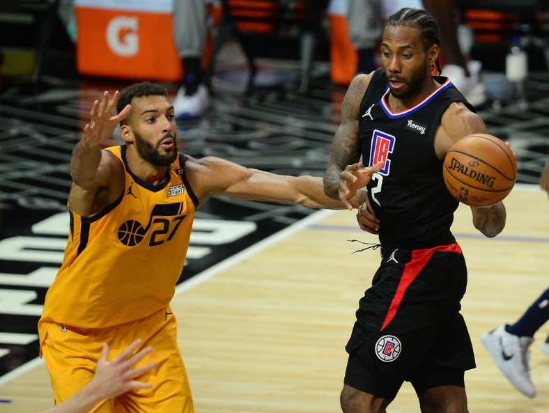 Jun 14, 2021; Los Angeles, California, USA; Los Angeles Clippers forward Kawhi Leonard (2) passes the ball against Utah Jazz center Rudy Gobert (27) during the second half in game four in the second round of the 2021 NBA Playoffs. at Staples Center. Mandatory Credit: Gary A. Vasquez-USA TODAY Sports