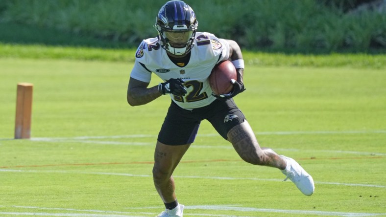 Jun 15, 2021; Owings Mills, Maryland, USA; Baltimore Ravens wide receiver Rashod Bateman (12) returns a punt during mandatory mini camp at the Under Armor Performance Center. Mandatory Credit: Mitch Stringer-USA TODAY Sports