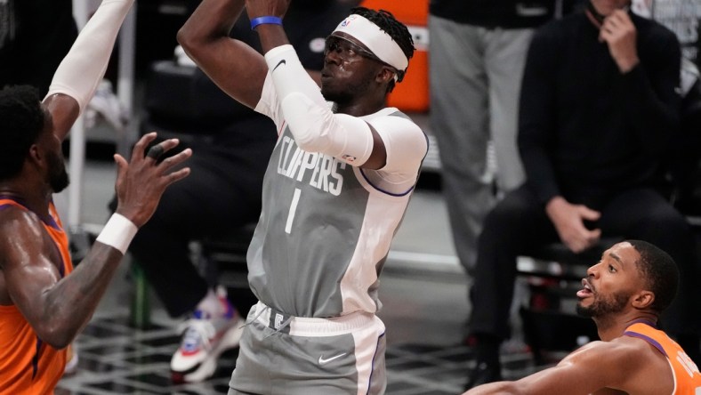 Jun 26, 2021; Los Angeles, California, USA; LA Clippers guard Reggie Jackson (1) shoots the ball against Phoenix Suns forward Jae Crowder (left) and forward Cameron Johnson (23) during the third quarter game four of the Western Conference Finals for the 2021 NBA Playoffs at Staples Center. Mandatory Credit: Robert Hanashiro-USA TODAY Sports