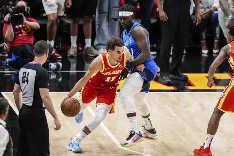 Jun 27, 2021; Atlanta, Georgia, USA; Atlanta Hawks guard Trae Young (11) controls the ball against Milwaukee Bucks guard Jrue Holiday (21) during the second half during game three of the Eastern Conference Finals for the 2021 NBA Playoffs at State Farm Arena. Mandatory Credit: Dale Zanine-USA TODAY Sports