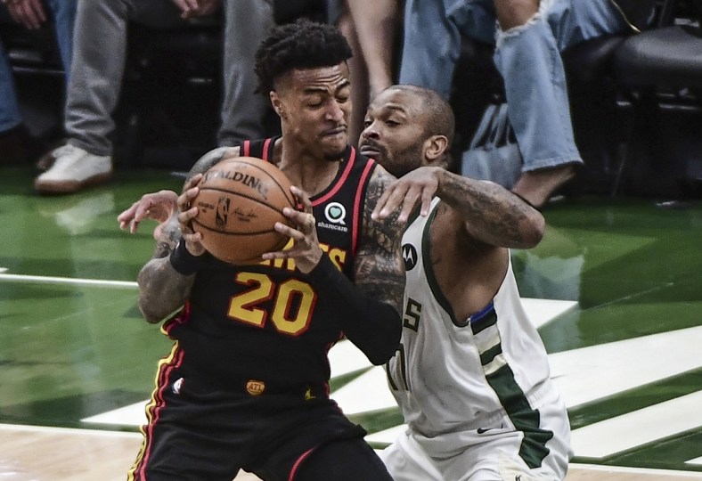 Jul 1, 2021; Milwaukee, Wisconsin, USA; Atlanta Hawks forward John Collins (20) gets pressure from Milwaukee Bucks forward P.J. Tucker (17) in the first quarter during game five of the Eastern Conference Finals for the 2021 NBA Playoffs at Fiserv Forum. Mandatory Credit: Benny Sieu-USA TODAY Sports