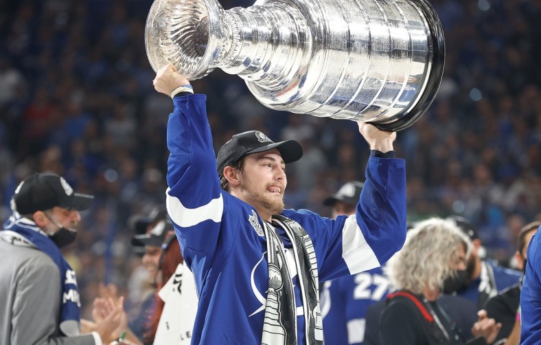 Jul 7, 2021; Tampa, Florida, USA;  Tampa Bay Lightning left wing Ross Colton (79) hoists the Stanley Cup after the Lightning defeated the Montreal Canadiens 1-0 in game five to win the 2021 Stanley Cup Final at Amalie Arena. Mandatory Credit: Kim Klement-USA TODAY Sports