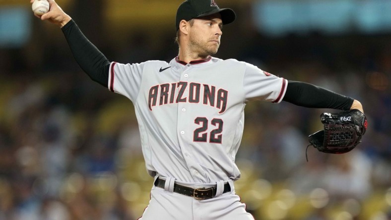 Jul 10, 2021; Los Angeles, California, USA; Arizona Diamondbacks right fielder Josh Reddick (22) pitches against the Los Angeles Dodgers in the eighth inning at Dodger Stadium. Mandatory Credit: Kirby Lee-USA TODAY Sports