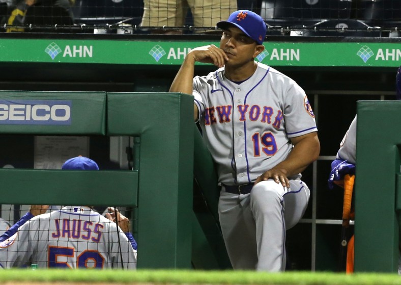 Jul 17, 2021; Pittsburgh, Pennsylvania, USA;  New York Mets manager Luis Rojas (19) looks on from the dugout against the Pittsburgh Pirates during the seventh inning at PNC Park. Mandatory Credit: Charles LeClaire-USA TODAY Sports