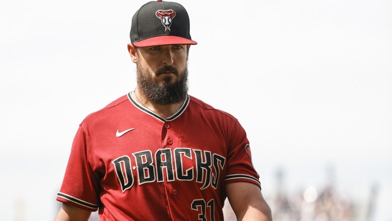 Jul 25, 2021; Chicago, Illinois, USA; Arizona Diamondbacks starting pitcher Caleb Smith (31) returns to dugout after pitching against the Chicago Cubs during the sixth inning at Wrigley Field. Mandatory Credit: Kamil Krzaczynski-USA TODAY Sports