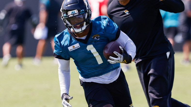 Jul 29, 2021; Jacksonville, FL, USA;  Jacksonville Jaguars running back Travis Etienne (1) participates in training camp at Dream Finders Homes practice field Mandatory Credit: Nathan Ray Seebeck-USA TODAY Sports