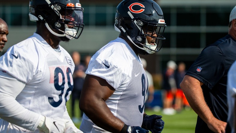 Jul 29, 2021; Lake Forest, IL, USA; Chicago Bears nose tackle Eddie Goldman (91) runs a lap around the field at the start of a Chicago Bears training camp session at Halas Hall. Mandatory Credit: Jon Durr-USA TODAY Sports