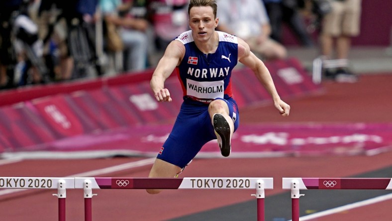 Jul 30, 2021; Tokyo, Japan; Karsten Warholm (NOR) competes in the men's 400m hurdles round 1 heat 3 during the Tokyo 2020 Olympic Summer Games at Olympic Stadium. Mandatory Credit: Andrew Nelles-USA TODAY Sports