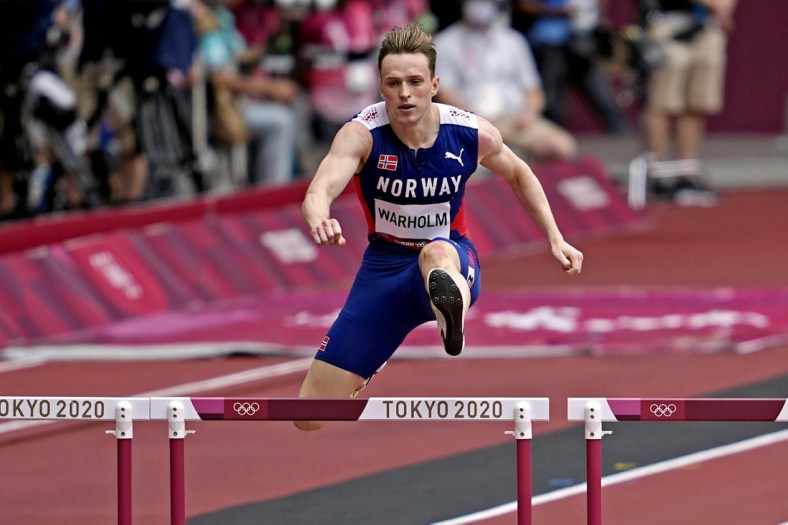 Jul 30, 2021; Tokyo, Japan; Karsten Warholm (NOR) competes in the men's 400m hurdles round 1 heat 3 during the Tokyo 2020 Olympic Summer Games at Olympic Stadium. Mandatory Credit: Andrew Nelles-USA TODAY Sports