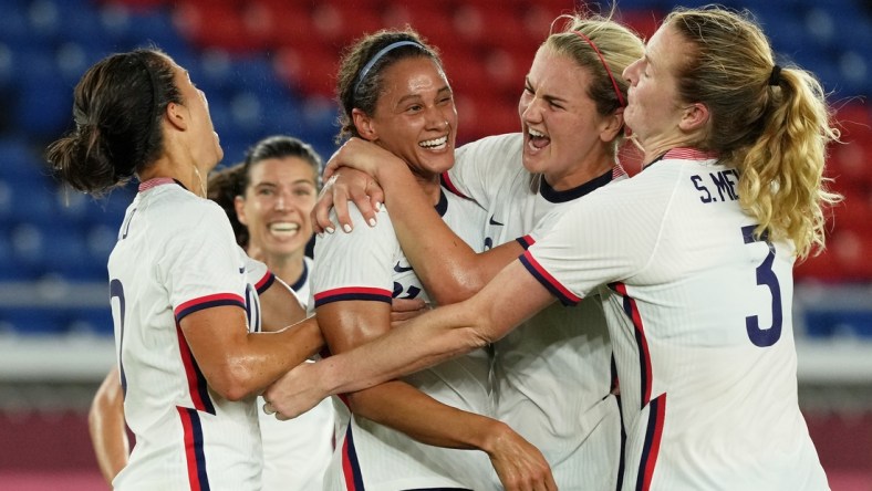 Jul 30, 2021; Yokohama, Japan; Team United States forward Lynn Williams (21) is congratulated after scoring against the Netherlands by midfielder Lindsey Horan (9) and forward Carli Lloyd (left) during the first half in a women's quarterfinals match during the Tokyo 2020 Olympic Summer Games at International Stadium Yokohama. Mandatory Credit: Jack Gruber-USA TODAY Sports