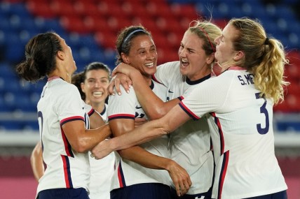 Jul 30, 2021; Yokohama, Japan; Team United States forward Lynn Williams (21) is congratulated after scoring against the Netherlands by midfielder Lindsey Horan (9) and forward Carli Lloyd (left) during the first half in a women's quarterfinals match during the Tokyo 2020 Olympic Summer Games at International Stadium Yokohama. Mandatory Credit: Jack Gruber-USA TODAY Sports