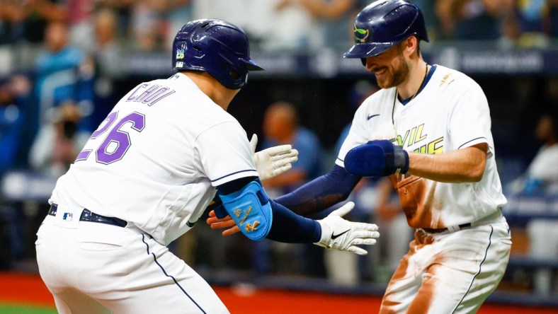 Jul 31, 2021; St. Petersburg, Florida, USA;  Tampa Bay Rays first baseman Ji-Man Choi (26) is congratulated by second baseman Brandon Lowe (8) after hitting a two-run home  run in the first inning at Tropicana Field. Mandatory Credit: Nathan Ray Seebeck-USA TODAY Sports