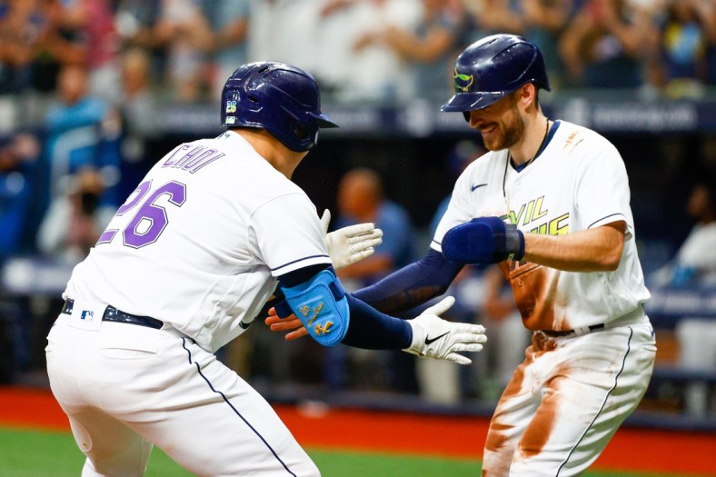 Jul 31, 2021; St. Petersburg, Florida, USA;  Tampa Bay Rays first baseman Ji-Man Choi (26) is congratulated by second baseman Brandon Lowe (8) after hitting a two-run home  run in the first inning at Tropicana Field. Mandatory Credit: Nathan Ray Seebeck-USA TODAY Sports