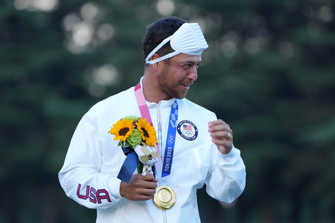 Aug 1, 2021; Tokyo, Japan; Xander Schauffele (USA) celebrates on the podium after winning the gold medal during the final round of the men's individual stroke play of the Tokyo 2020 Olympic Summer Games at Kasumigaseki Country Club. Mandatory Credit: Kyle Terada-USA TODAY Sports