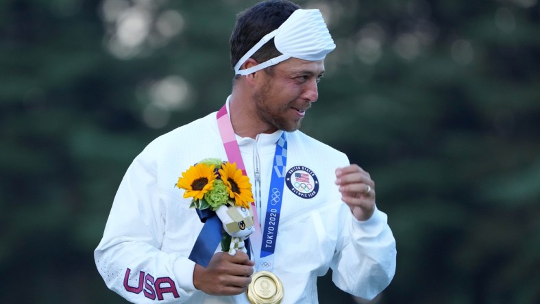 Aug 1, 2021; Tokyo, Japan; Xander Schauffele (USA) celebrates on the podium after winning the gold medal during the final round of the men's individual stroke play of the Tokyo 2020 Olympic Summer Games at Kasumigaseki Country Club. Mandatory Credit: Kyle Terada-USA TODAY Sports