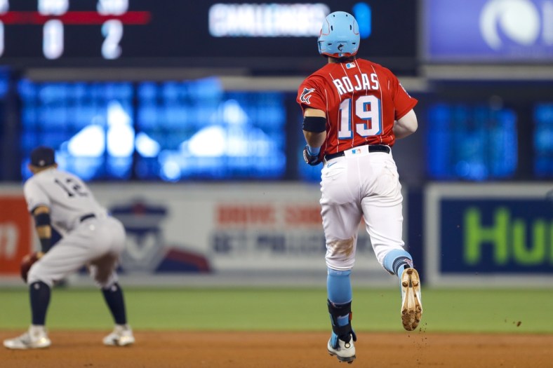 Aug 1, 2021; Miami, Florida, USA; Miami Marlins shortstop Miguel Rojas (19) runs toward second base for a double during the first inning of the game against the New York Yankees at loanDepot Park. Mandatory Credit: Sam Navarro-USA TODAY Sports