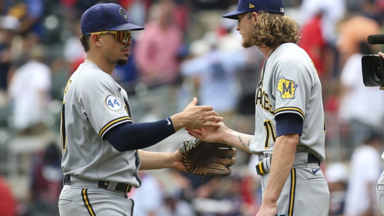 Aug 1, 2021; Atlanta, Georgia, USA; Milwaukee Brewers shortstop Willy Adames (27) and relief pitcher Josh Hader (71) celebrate a victory against the Atlanta Braves at Truist Park. Mandatory Credit: Brett Davis-USA TODAY Sports