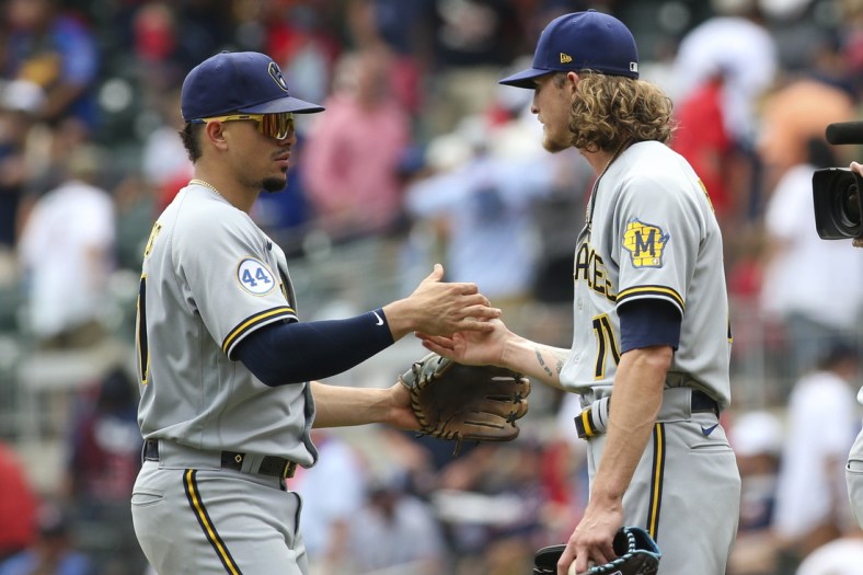Aug 1, 2021; Atlanta, Georgia, USA; Milwaukee Brewers shortstop Willy Adames (27) and relief pitcher Josh Hader (71) celebrate a victory against the Atlanta Braves at Truist Park. Mandatory Credit: Brett Davis-USA TODAY Sports