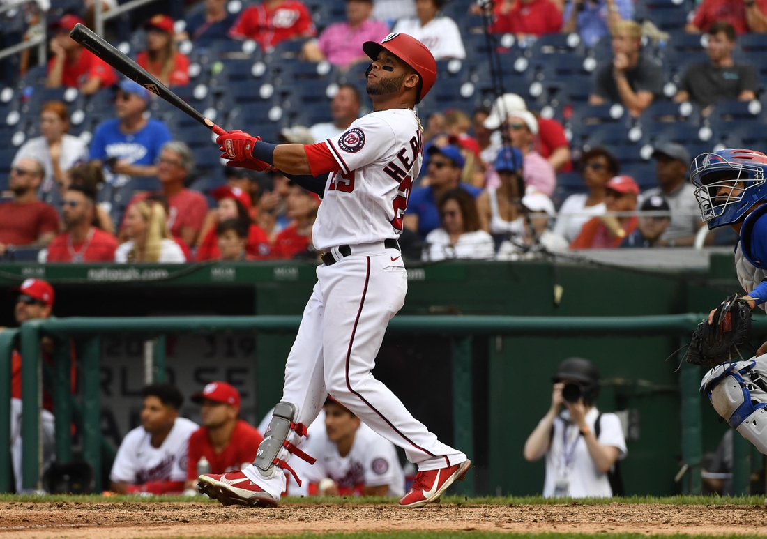 Aug 1, 2021; Washington, District of Columbia, USA; Washington Nationals left fielder Yadiel Hernandez (29) watches his walk off home run against the Chicago Cubs during the ninth inning at Nationals Park. Mandatory Credit: Brad Mills-USA TODAY Sports