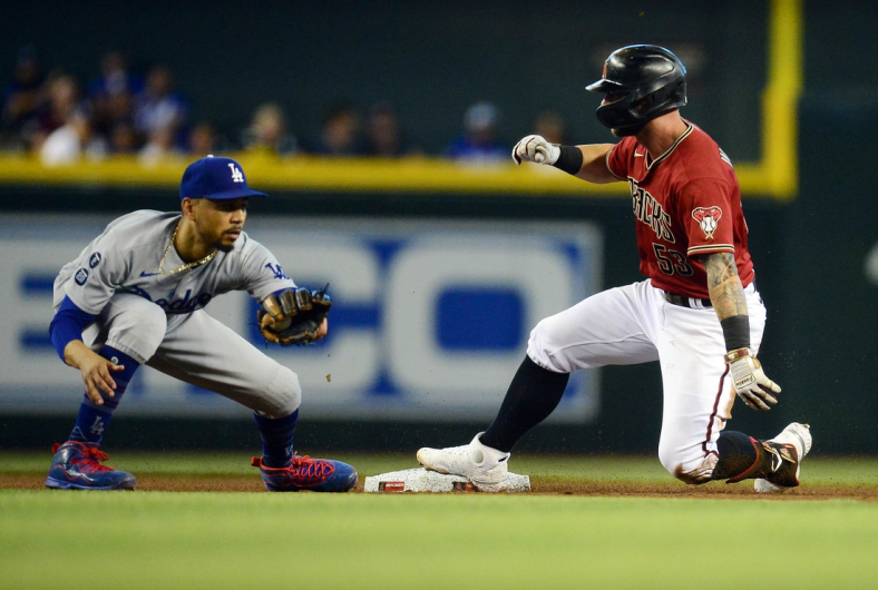 Aug 1, 2021; Phoenix, Arizona, USA; Arizona Diamondbacks first baseman Christian Walker (53) reaches second against Los Angeles Dodgers second baseman Mookie Betts (50) after hitting a single during the fourth inning at Chase Field. Mandatory Credit: Gary A. Vasquez-USA TODAY Sports