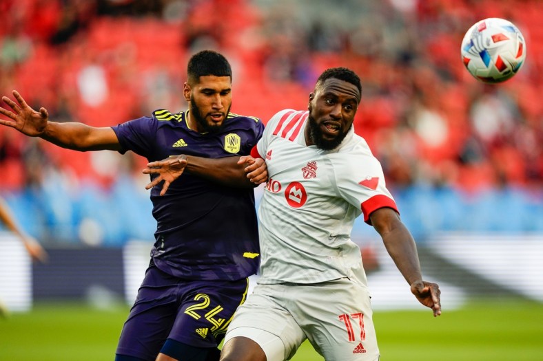Aug 1, 2021; Toronto, Ontario, CAN; Toronto FC forward Jozy Altidore (17) battles for the ball against Nashville SC defender Robert Castellanos (24) during the first half at BMO Field. Mandatory Credit: Kevin Sousa-USA TODAY Sports
