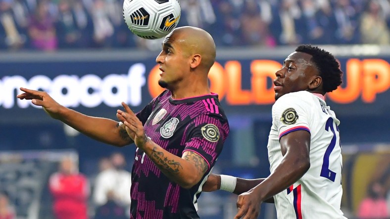 Aug 1, 2021; Las Vegas, Nevada, USA; Mexico defender Luis Rodriguez (21) heads the ball in front of USA defender George Bello (21) during the first half of the CONCACAF Gold Cup final soccer match at Allegiant Stadium. Mandatory Credit: Stephen R. Sylvanie-USA TODAY Sports