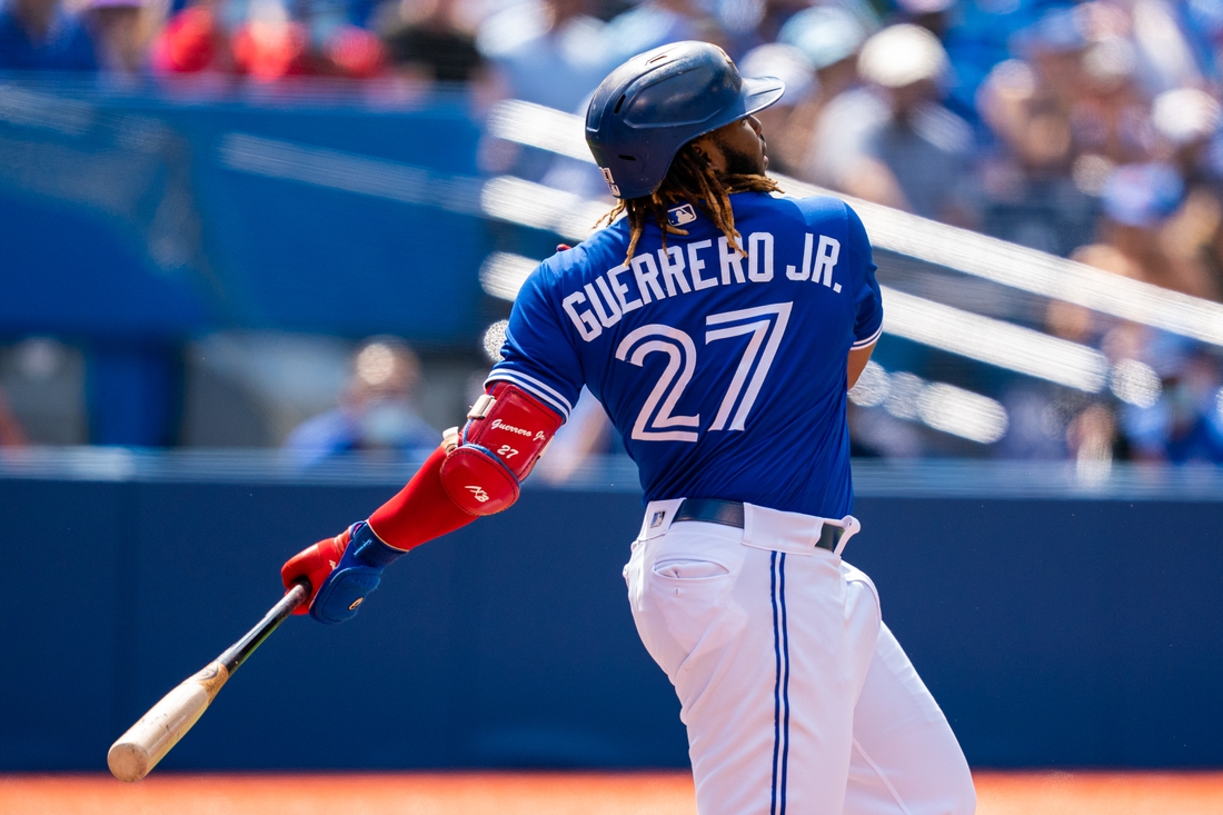 Aug 2, 2021; Toronto, Ontario, CAN; Toronto Blue Jays first baseman Vladimir Guerrero Jr. (27) hits a single against the Cleveland Indians during the first inning at Rogers Centre. Mandatory Credit: Kevin Sousa-USA TODAY Sports