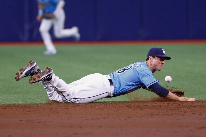 Aug 2, 2021; St. Petersburg, Florida, USA; Tampa Bay Rays third baseman Joey Wendle (18) dives for the ball in the third inning against the Seattle Mariners at Tropicana Field. Mandatory Credit: Nathan Ray Seebeck-USA TODAY Sports