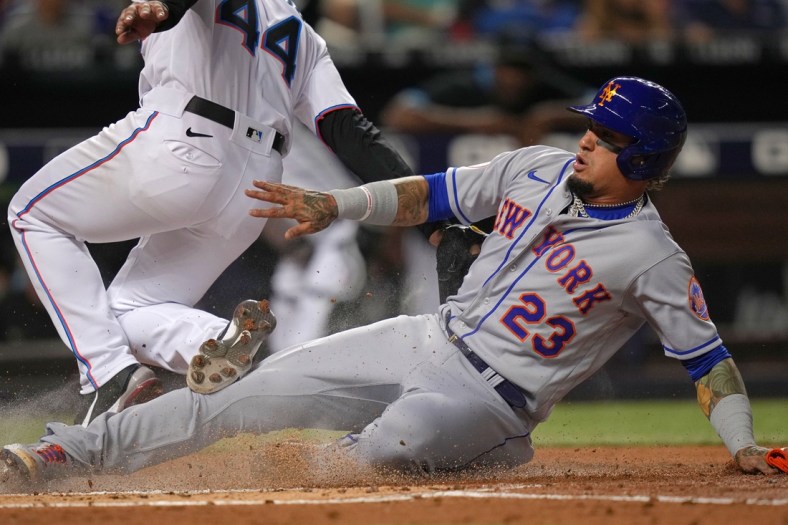 Aug 2, 2021; Miami, Florida, USA; New York Mets shortstop Javier Baez (23) scores a run on a wild pitch by Miami Marlins starting pitcher Jesus Luzardo (44) in the 2nd inning at loanDepot park. Mandatory Credit: Jasen Vinlove-USA TODAY Sports