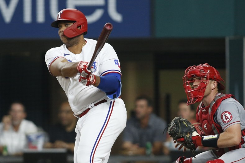 Aug 2, 2021; Arlington, Texas, USA; Texas Rangers designated hitter Curtis Terry (83) hits a double for his first major league hit in the second inning against the Los Angeles Angels at Globe Life Field. Mandatory Credit: Tim Heitman-USA TODAY Sports