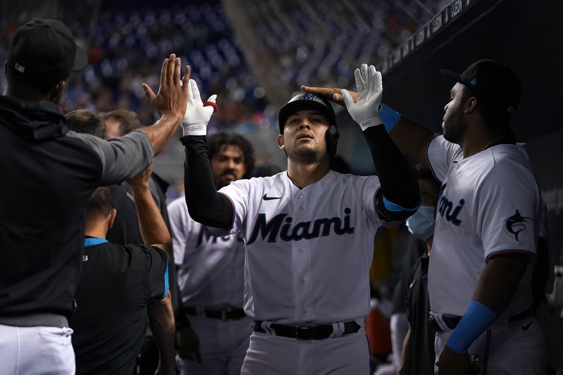 Aug 2, 2021; Miami, Florida, USA; Miami Marlins catcher Alex Jackson (23) celebrates in the dugout with teammates after hitting a solo homerun in the 2nd inning against the New York Mets at loanDepot park. Mandatory Credit: Jasen Vinlove-USA TODAY Sports