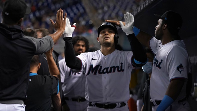 Aug 2, 2021; Miami, Florida, USA; Miami Marlins catcher Alex Jackson (23) celebrates in the dugout with teammates after hitting a solo homerun in the 2nd inning against the New York Mets at loanDepot park. Mandatory Credit: Jasen Vinlove-USA TODAY Sports