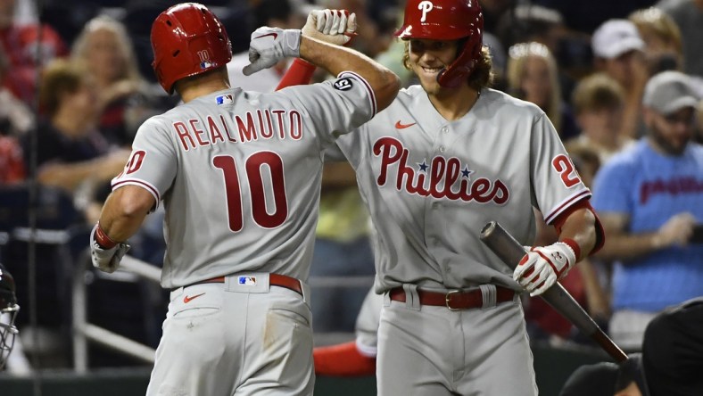 Aug 3, 2021; Washington, District of Columbia, USA; Philadelphia Phillies catcher J.T. Realmuto (10) celebrates with third baseman Alec Bohm (28) after hitting a home run against the Washington Nationals during the seventh inning at Nationals Park. Mandatory Credit: Brad Mills-USA TODAY Sports