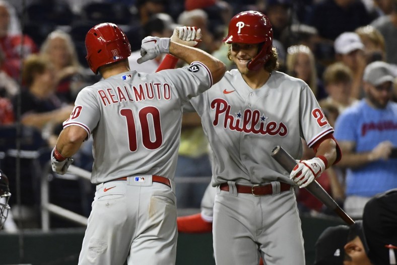 Aug 3, 2021; Washington, District of Columbia, USA; Philadelphia Phillies catcher J.T. Realmuto (10) celebrates with third baseman Alec Bohm (28) after hitting a home run against the Washington Nationals during the seventh inning at Nationals Park. Mandatory Credit: Brad Mills-USA TODAY Sports