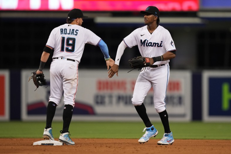 Aug 2, 2021; Miami, Florida, USA; Miami Marlins shortstop Miguel Rojas (19) and center fielder Lewis Brinson (25) celebrate after defeating the New York Mets at loanDepot park. Mandatory Credit: Jasen Vinlove-USA TODAY Sports