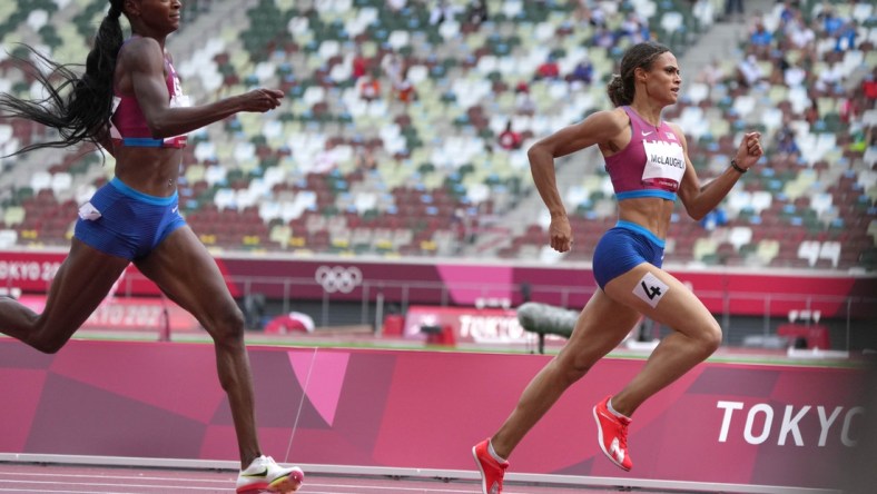 Aug 4, 2021; Tokyo, Japan; Sydney McLaughlin (USA), right, defeats Dalilah Muhammad (USA) to win the women's 400m hurdles n a world record 51.46 to 51.58 during the Tokyo 2020 Olympic Summer Games at Olympic Stadium. Mandatory Credit: Kirby Lee-USA TODAY Sports