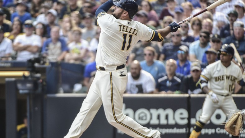 Aug 4, 2021; Milwaukee, Wisconsin, USA; Milwaukee Brewers first baseman Rowdy Tellez (11) hits a three-run home run in the seventh inning against the Pittsburgh Pirates at American Family Field. Mandatory Credit: Benny Sieu-USA TODAY Sports