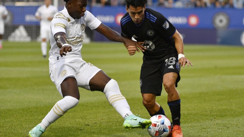 Aug 4, 2021; Montreal, Quebec, CAN; CF Montreal midfielder Joaquin Torres (18) plays the ball as Atlanta United FC defender George Bello (21) defends during the first half at Stade Saputo. Mandatory Credit: Eric Bolte-USA TODAY Sports