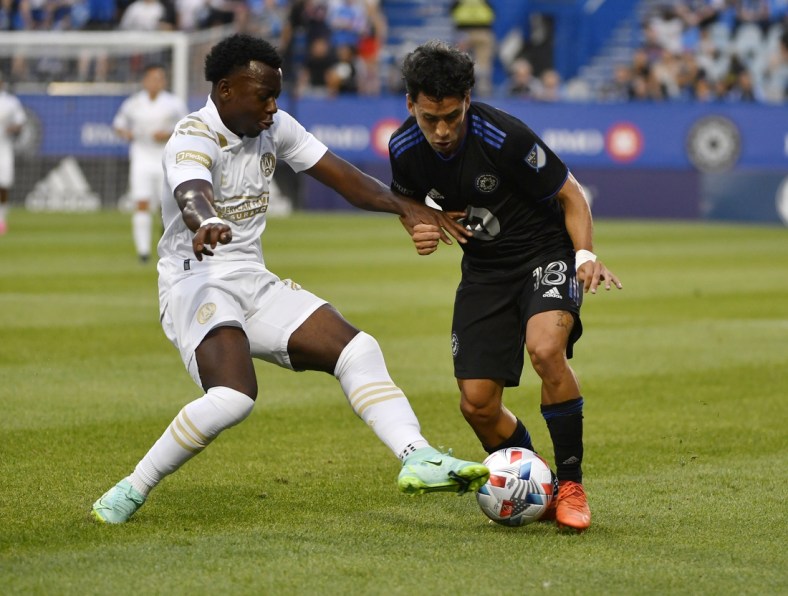 Aug 4, 2021; Montreal, Quebec, CAN; CF Montreal midfielder Joaquin Torres (18) plays the ball as Atlanta United FC defender George Bello (21) defends during the first half at Stade Saputo. Mandatory Credit: Eric Bolte-USA TODAY Sports