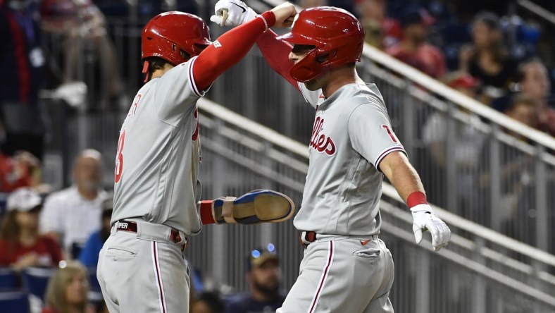 Aug 4, 2021; Washington, District of Columbia, USA; Philadelphia Phillies first baseman Rhys Hoskins (right) is congratulated by right fielder Bryce Harper (left) after hitting a two-run home run against the Washington Nationals during the fifth inning at Nationals Park. Mandatory Credit: Brad Mills-USA TODAY Sports