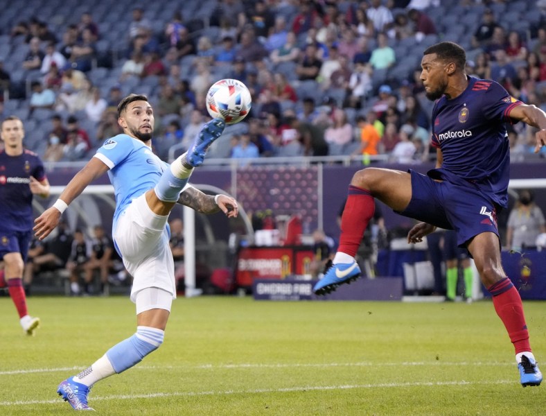 Aug 4, 2021; Chicago, Illinois, USA; New York City midfielder Valentin Castellanos (11) and Chicago Fire defender Johan Kappelhof (4) play for the ball during the first half at Soldier Field. Mandatory Credit: Mike Dinovo-USA TODAY Sports