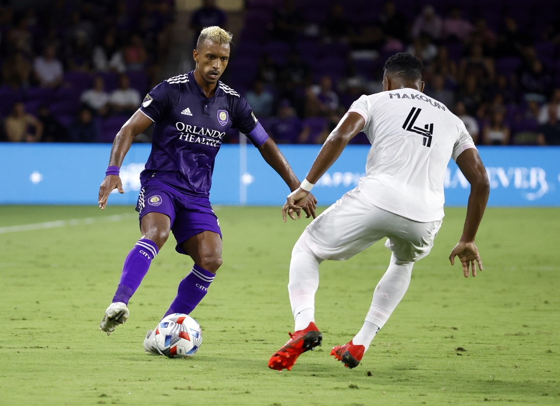 Aug 4, 2021; Orlando, Florida, USA; Orlando City SC forward Nani (17) dribbles the ball as Inter Miami CF defender Christian Makoun (4) defends during the first half at Orlando City Stadium. Mandatory Credit: Kim Klement-USA TODAY Sports